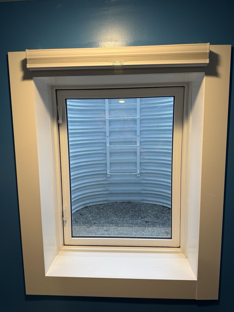 Basement egress window seen from inside the finished room