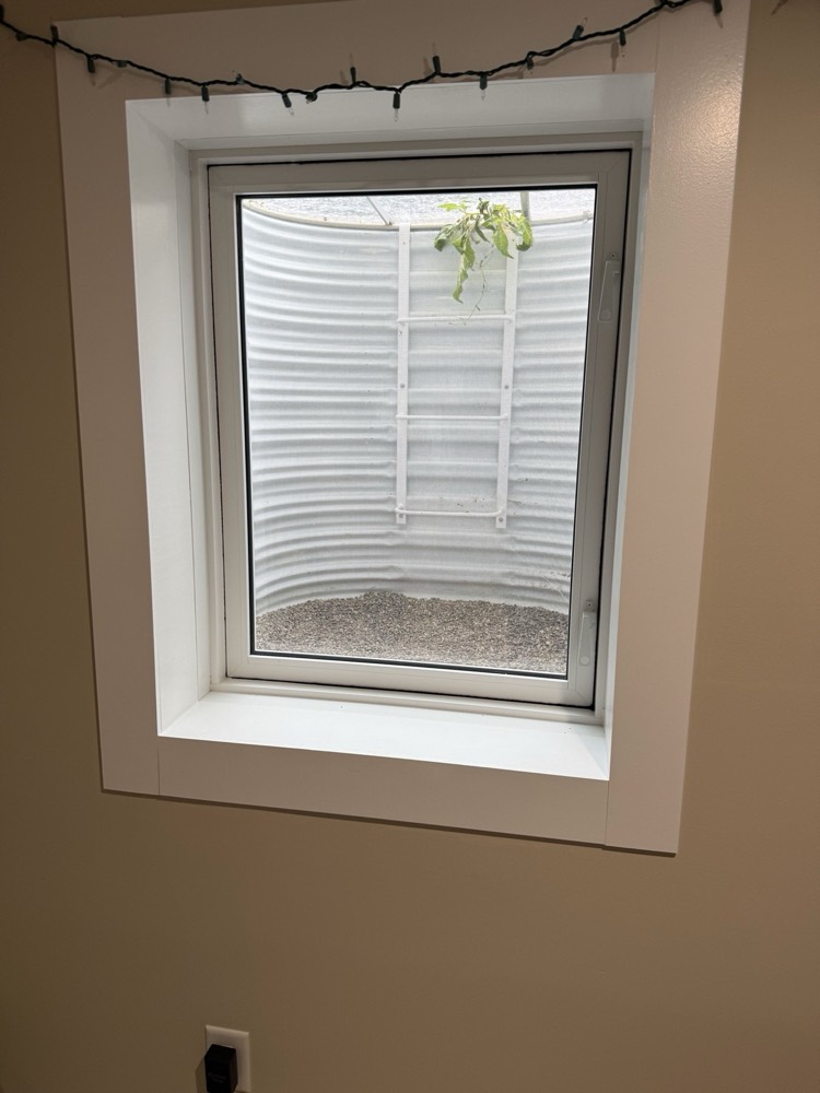 Egress window bringing daylight into a finished basement room