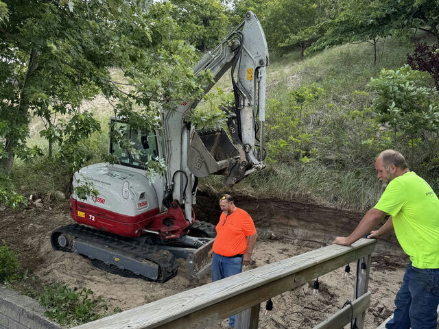 Removing the old wall and excavating the slope